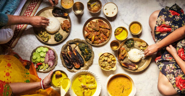 A family eating a variety of traditional Indian vegan food together