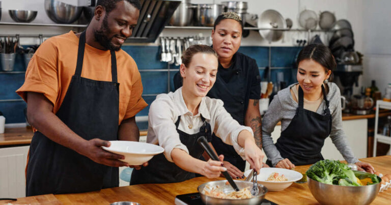 Kitchen staff learning how to cook a new plant-based dish during a training workshop at the restaurant