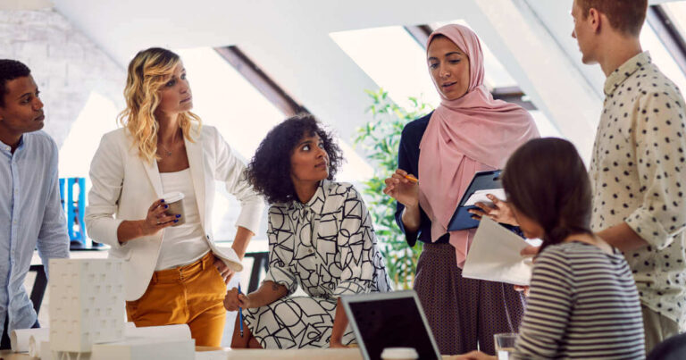 A business meeting at the office with employees from diverse cultural backgrounds