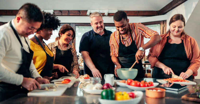 A team of colleagues having fun together in a plant-based cooking class